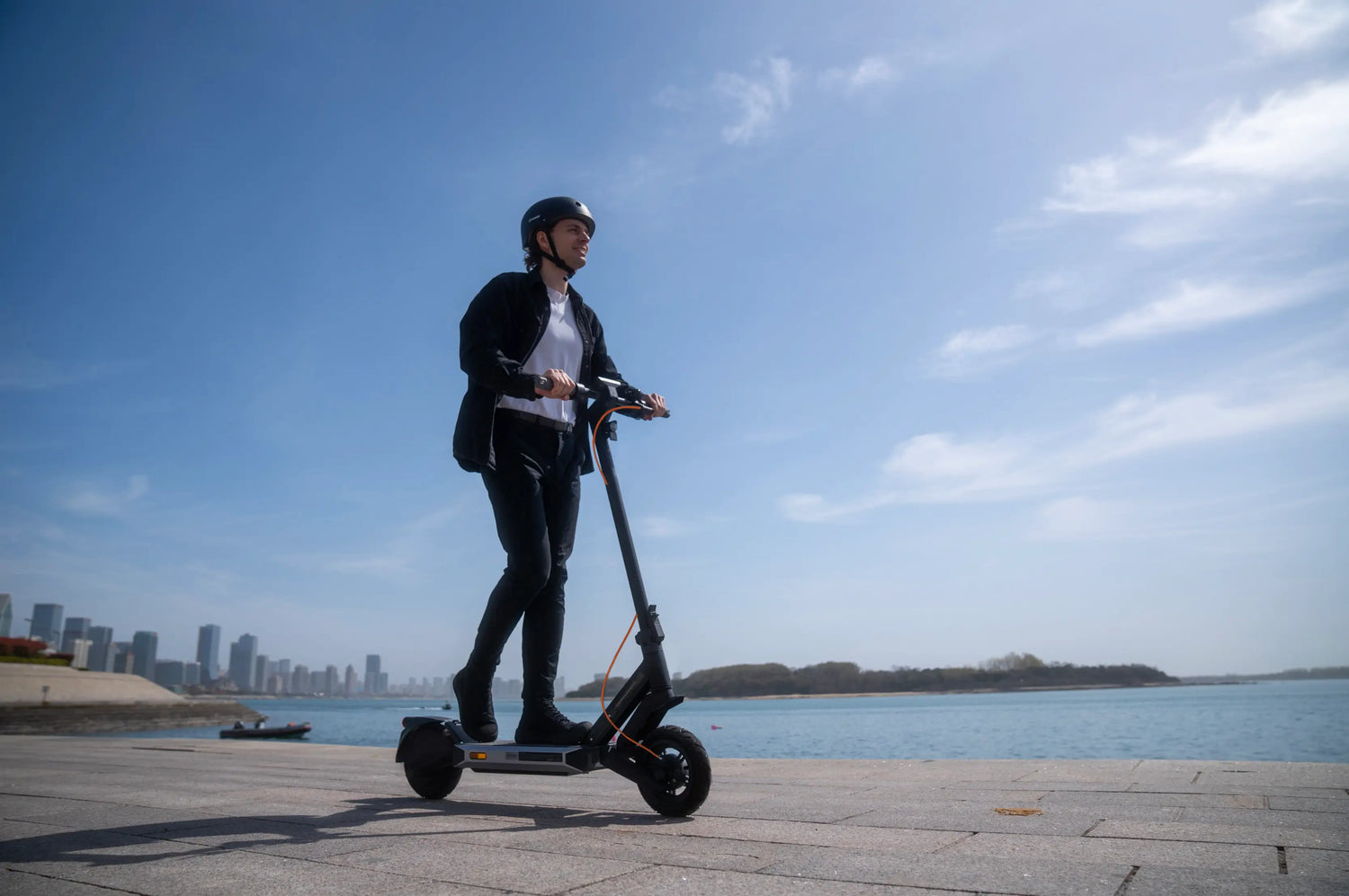 Rider on an electric scooter by the waterfront