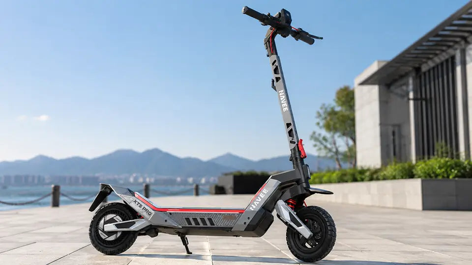 AVEE electric scooter parked outdoors on a sunny waterfront promenade