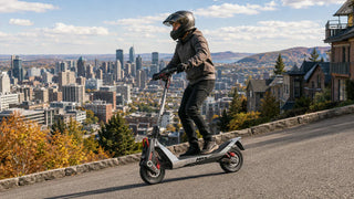 Electric scooter rider climbing a steep Canadian city hill