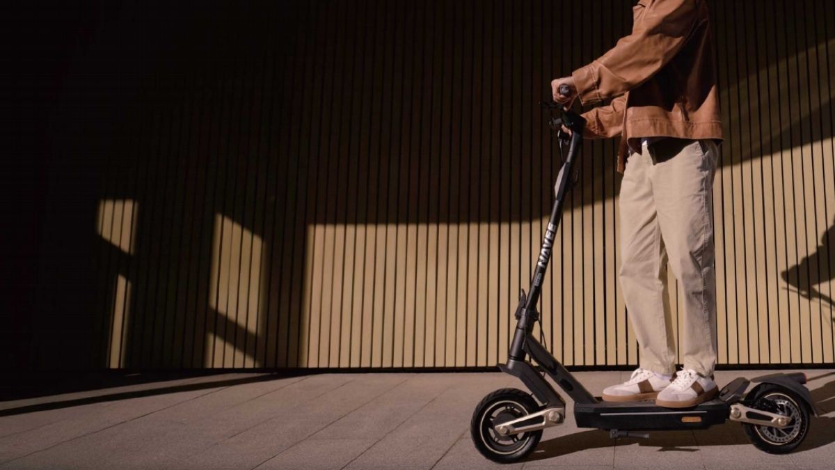 A man are riding Navee electric scooter.